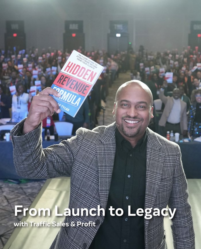 Lamar Tyler holding The Hidden Revenue Formula on stage